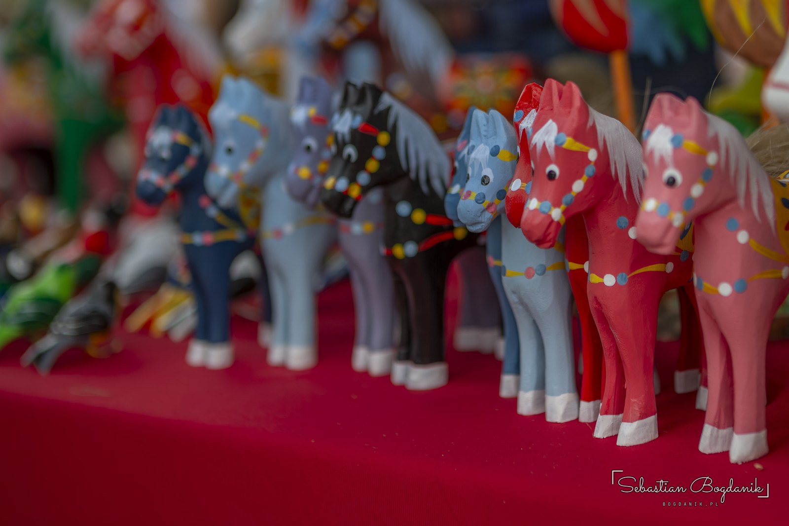 A row of painted horses, each one slightly different.