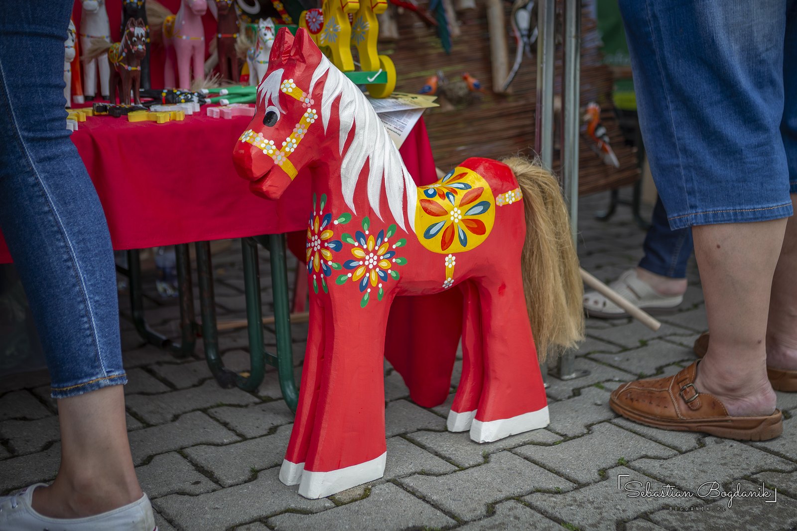 A large red horse with a real mane and tail.