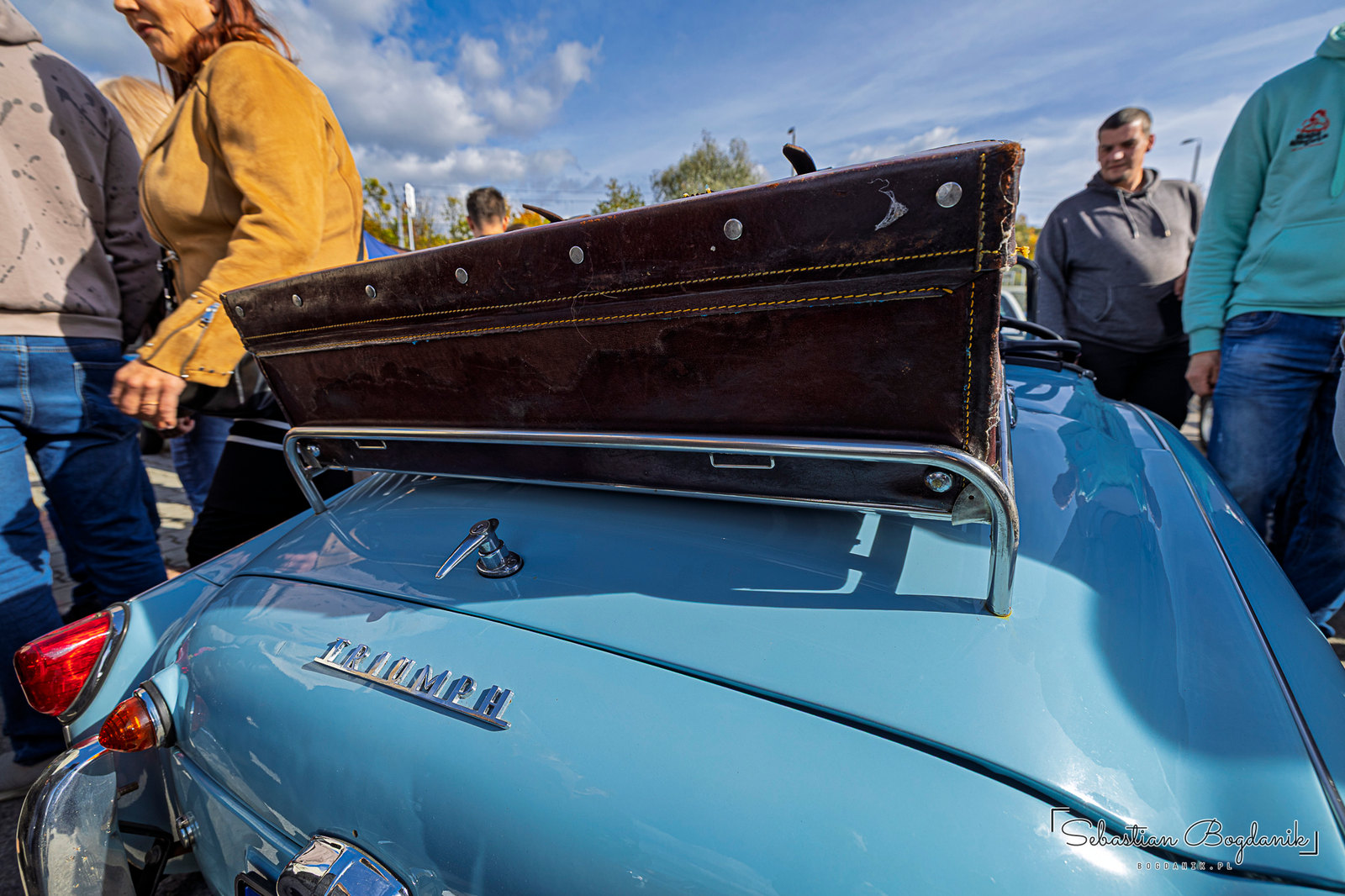 A British Triumph with a suitcase on the rack and a dash full of round gauges (1/2)