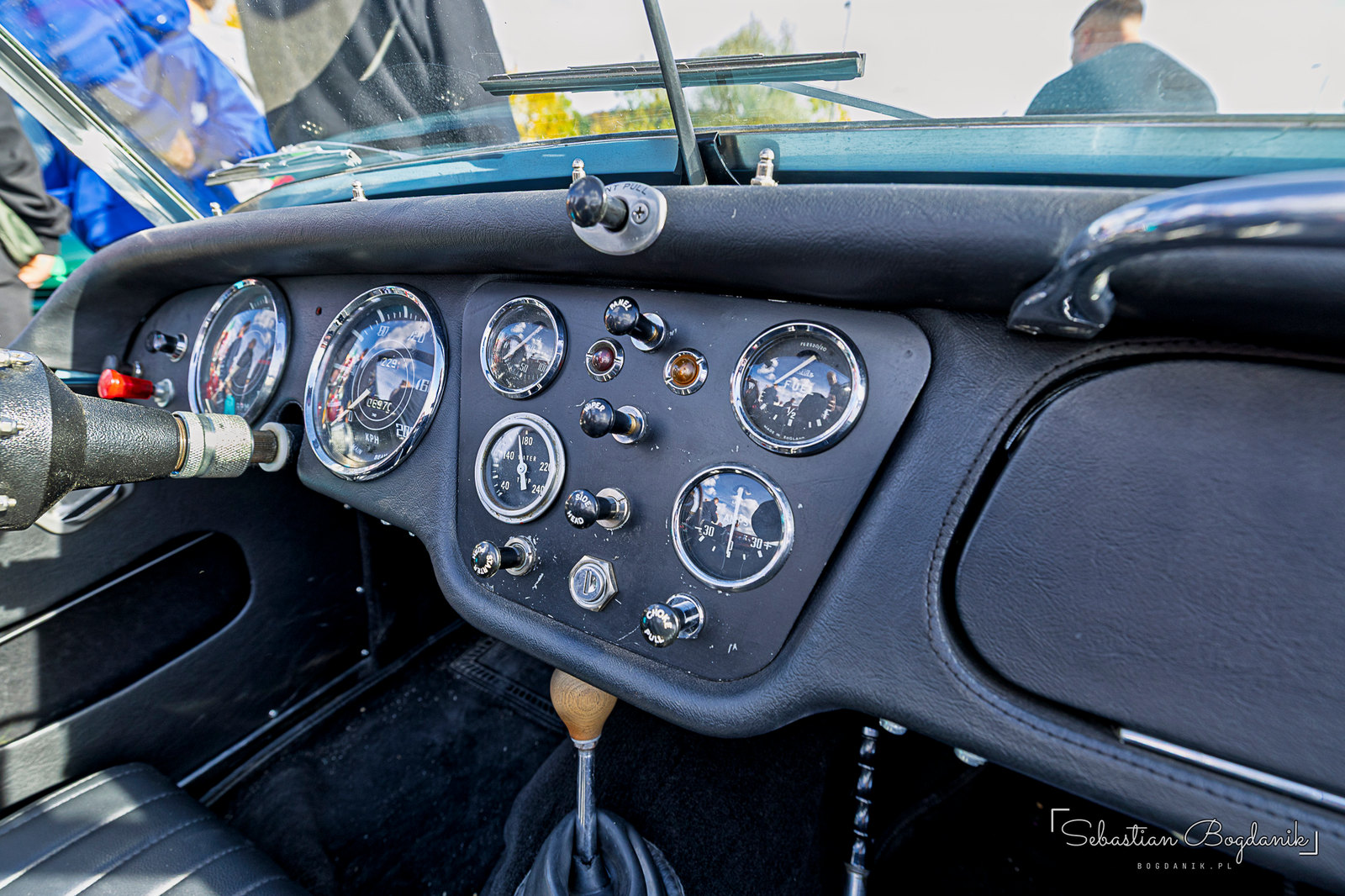 A British Triumph with a suitcase on the rack and a dash full of round gauges (2/2)