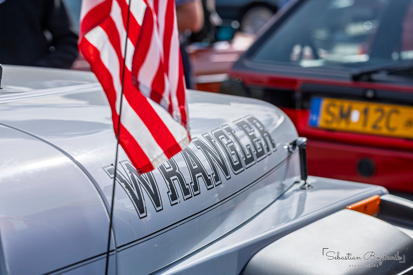 A Jeep Wrangler flying the Stars and Stripes like it is the Fourth of July